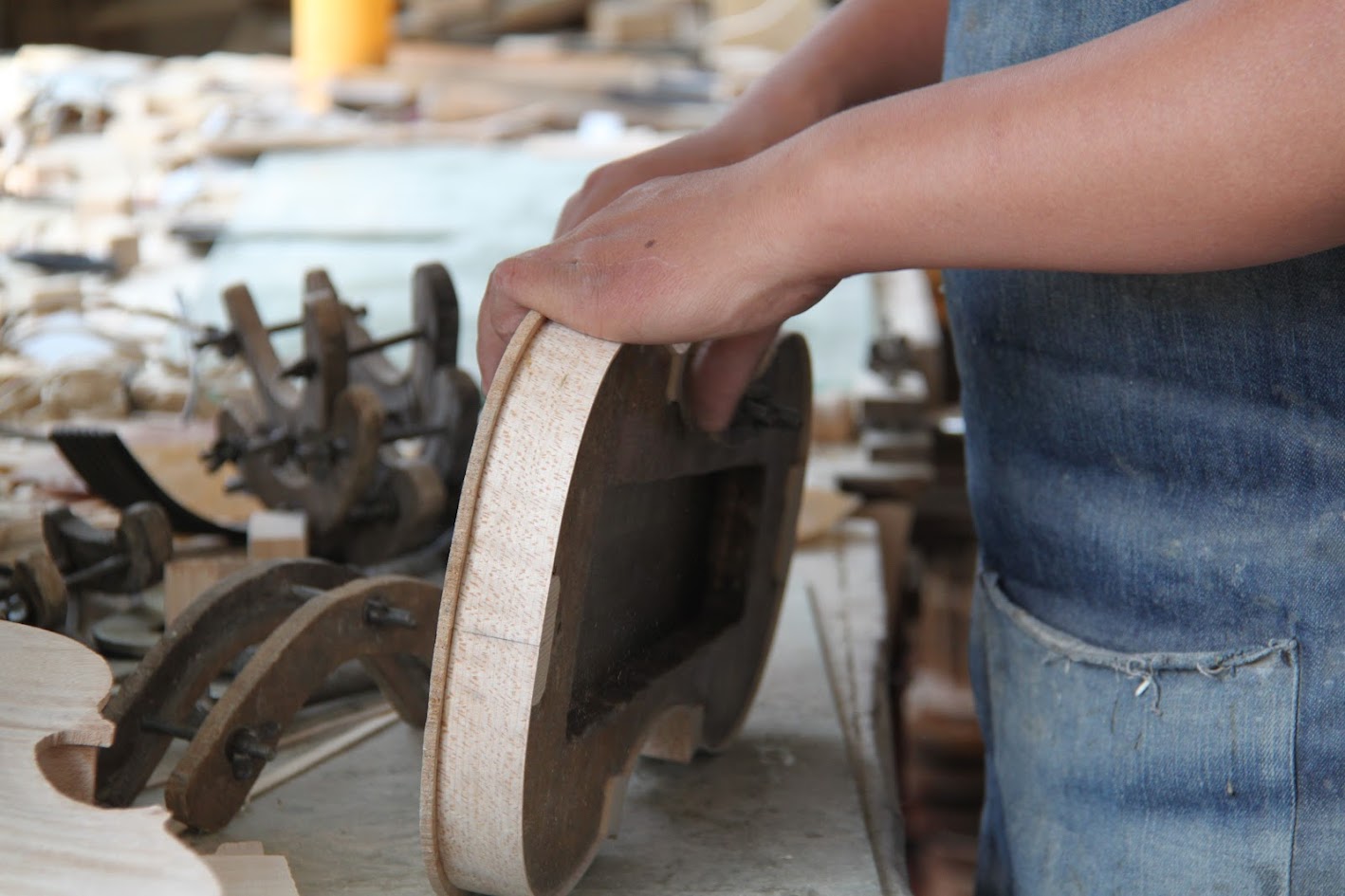 A detailed view of a woman playing a violin, highlighting her focus and the instrument's texture.