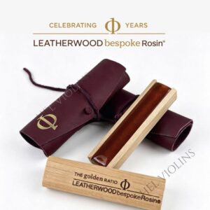 Amber violin rosin in a wooden case with a burgundy leather sleeve, branded Leatherwood bespoke Rosin.